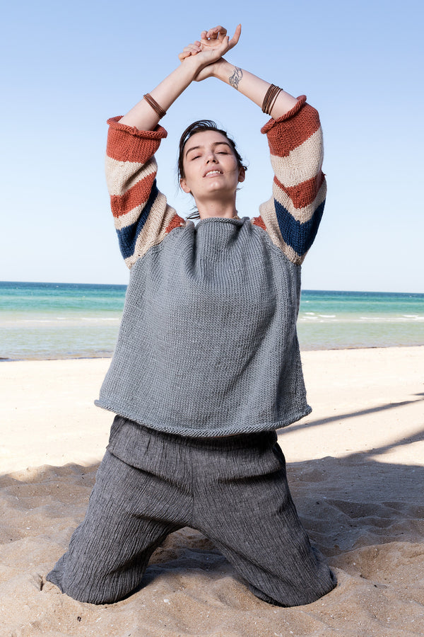 Wool hand-knitted wide jumper with striped sleeves