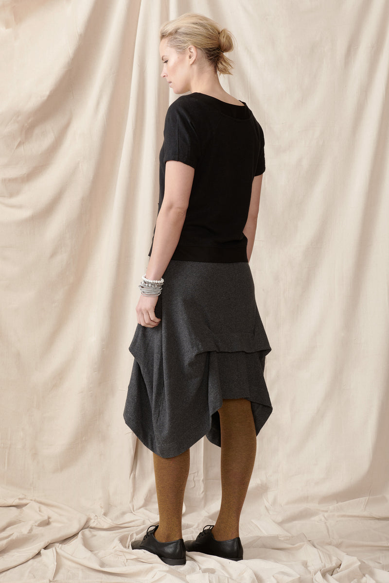 Back of trans-seasonal skirt with pleat detail