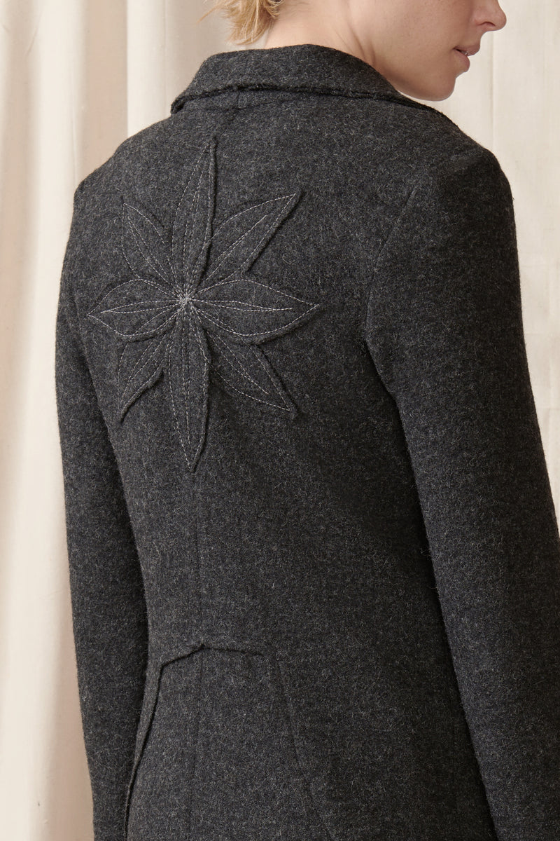 Close up of raw edge applique detail on boiled wool coat