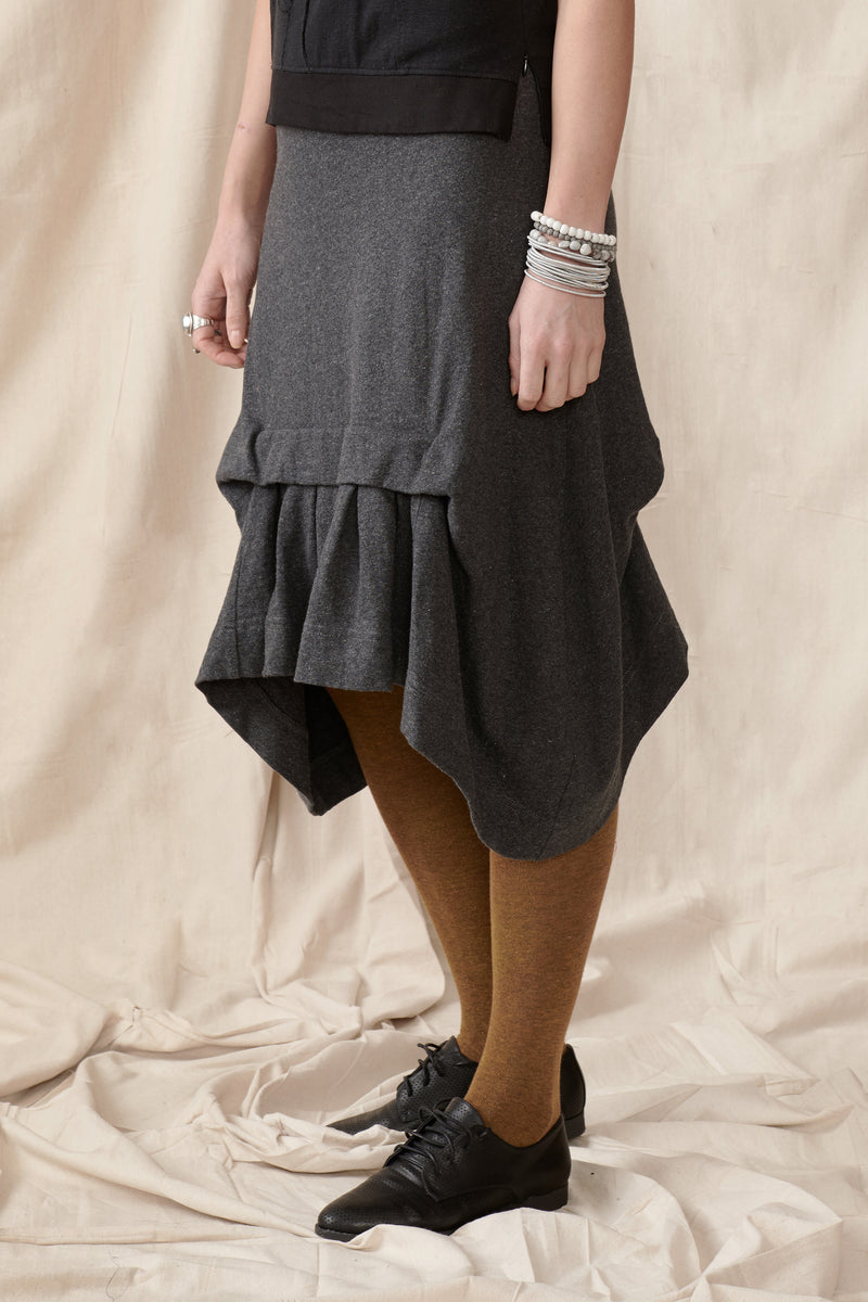 Asymmetrical hem charcoal skirt with front pleat detail