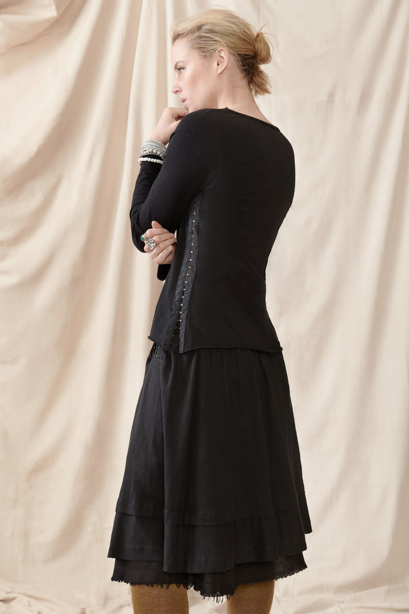 Back of black skirt and black long sleeve top showing hook and eye detail 