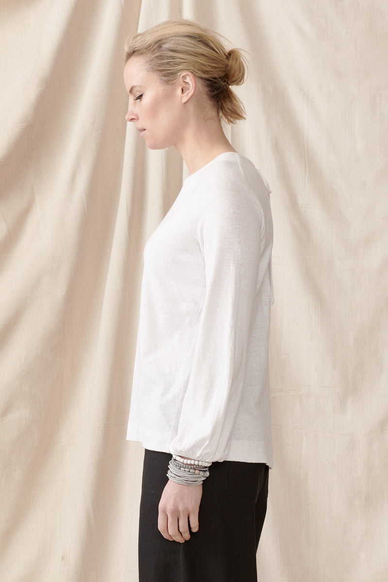 Side view of long bell sleeved top