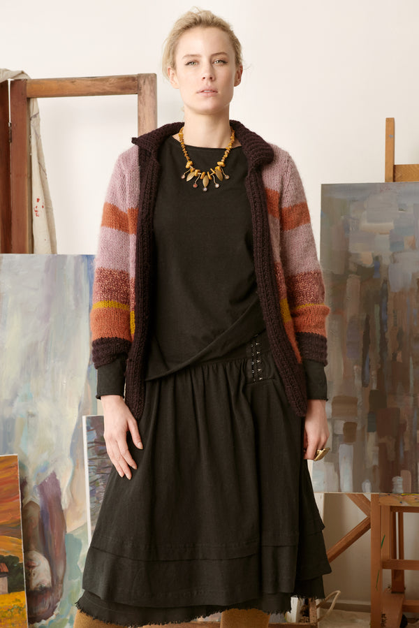 Black skirt with black long sleeved top and multi coloured cardigan